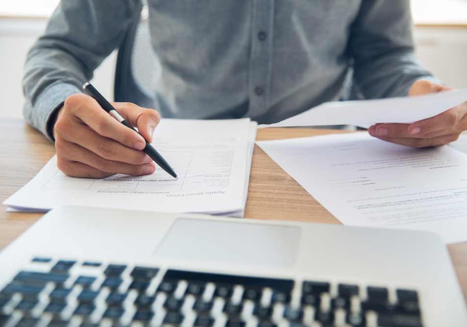businessman-checking-documents-table